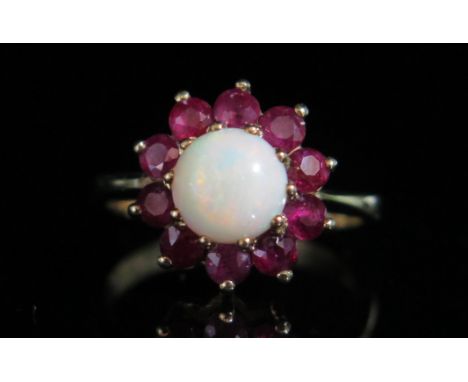 A 9ct Gold, Opal and Red Stone Cluster Ring, size P.5, hallmarked, 3.8g 