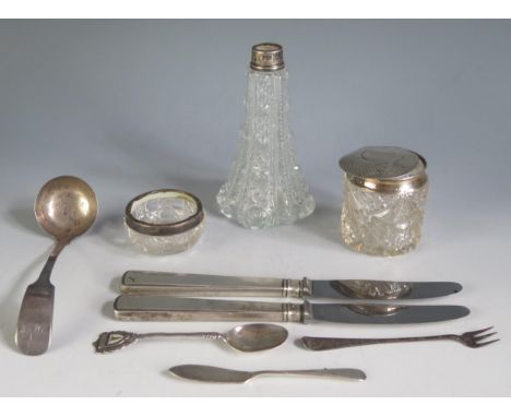 A mixed collection of silver wares, includes clear glass and silver mounted jars, silver handled knives, sauce ladle etc weig