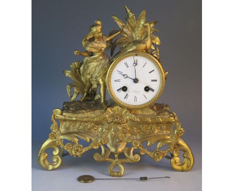 Henry Marc, Paris, a late 19th century gilt metal figural mantel clock, surmounted by a peacock and female, on a scroll decor