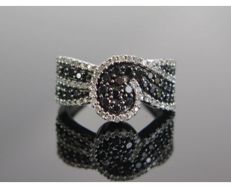 A 9ct White Gold, Black and White Diamond Dress Ring, size M.5, hallmarked, 4.58g 
