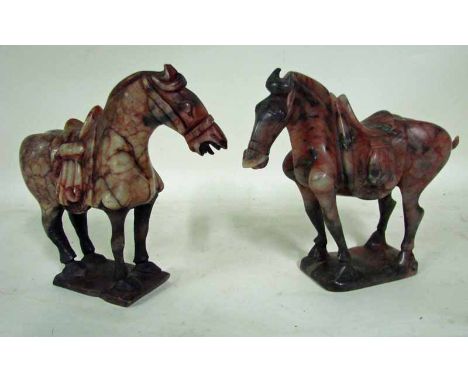 A pair of Chinese carved red veined jade Tang style horses, on integral rectangular bases, 18.5cm high 