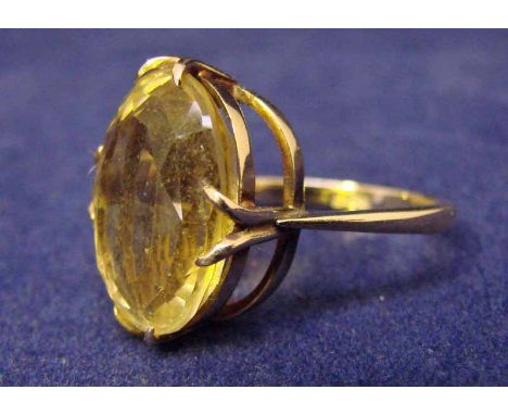 A 9ct gold ring set with large oval citrine, facet cut, two-tier mount, citrine 13mm long, ring size M.5