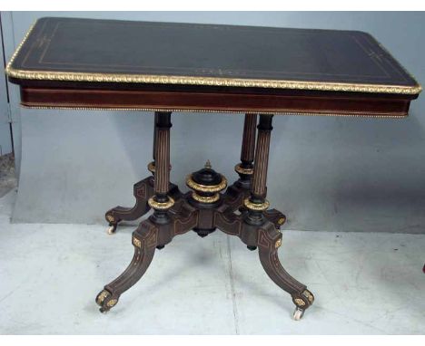 An Empire style gilt and ebonised card table, the rectangular top with gilt moulded edge hinged to reveal green beize playing