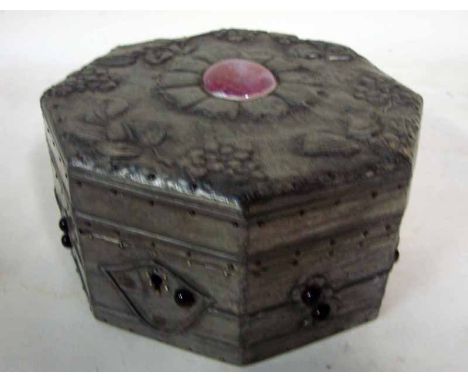 An Arts Nouveau wooden lidded box of octagonal form, all visible surfaces covered in pewter sheet, the hinged cover centrally