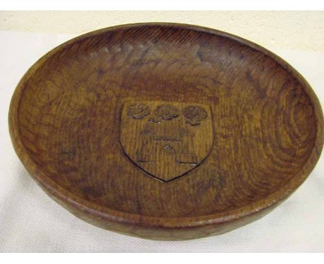 An adzed wooden fruit bowl of circular form by Derek ‘Lizard Man’ Slater, centrally carved with a sheild featuring three rose