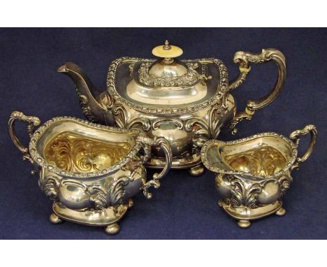 A late Victorian silver three-piece bachelor tea service by William Aitken, boat shape form, heavily decorated in a Rococco s