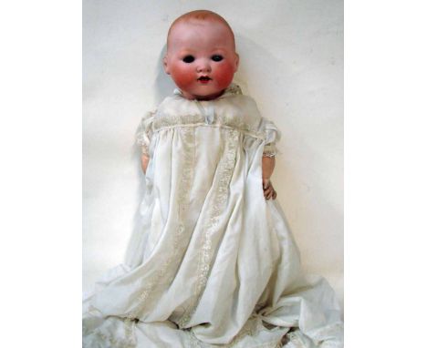 A German bisque head doll by Armand Marseille, sleeping blue eyes, open mouth, composite body, head stamped A.M Germany. 351.
