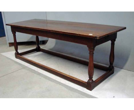 An oak refectory table of typical form, rectangular three plank top with crossbanded ends, plain frieze with drawer at one en