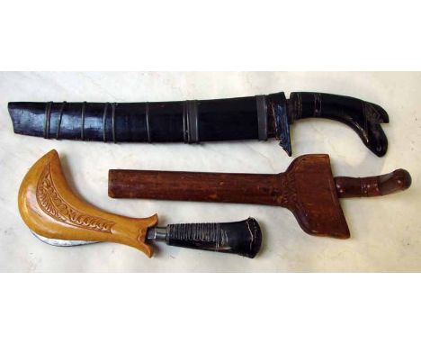 Three oriental daggers/knives including an Indonesian Kriss with wooden hilt and scabbard, 20cm blade, a large hunting knife 