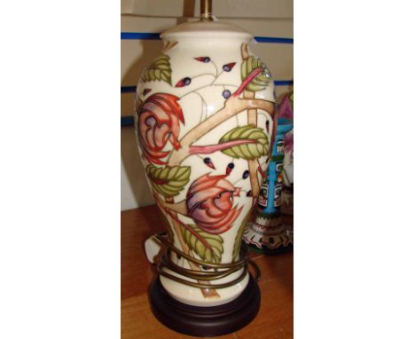 A late 20th century Moorcroft Pottery table lamp of inverted baluster form, tubeline decorated with stylised foliage on an iv