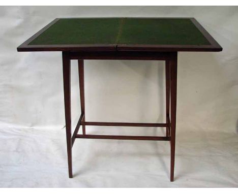 A small mahogany games table, cross banded hinged rectangular top with moulded edge, opens and rotates to reveal beize surfac