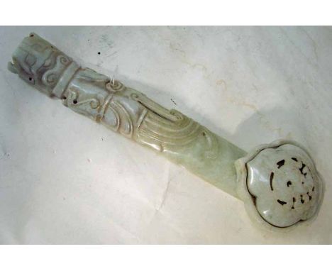A Chinese pale jade Ruyi Sceptre, carved and pierced to the front with various stylised designs, 25.5cm long 