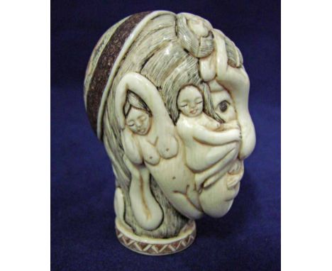 An oriental carved ivory head decorated with various nude female figures, 8cm high 