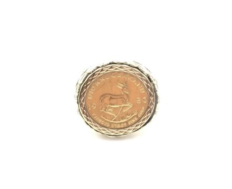 A 9ct gold ring set with a 1980 1/10oz gold krugerrand. Size N and 7.64g