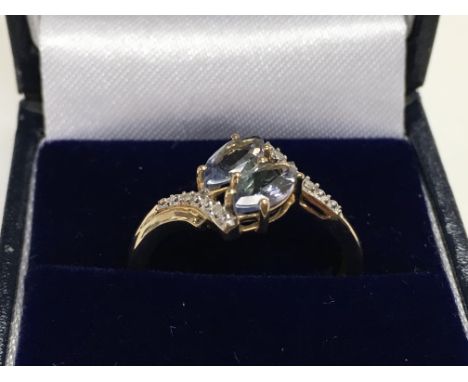 9ct yellow gold double marquise cut lilac tourmaline and diamond ring. Boxed. Ring size Approx P. Postage category A.