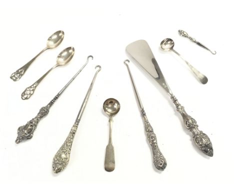 A Collection of silver hallmarked items including button hooks, spoons