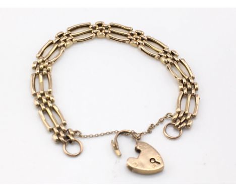 A 9ct gold gate bracelet with heart padlock. 11.62g Postage A