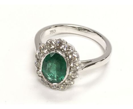 18ct white gold ring with an oval emerald and a halo of RBC diamonds in a beaded setting. Emerald 1.08ct. Diamonds 0.57ct. Ri
