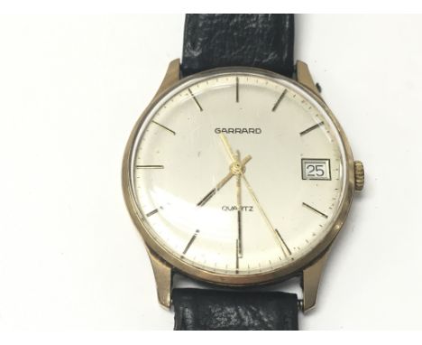 A vintage gents 9ct Garrard wrist watch with leather strap. Not seen running.