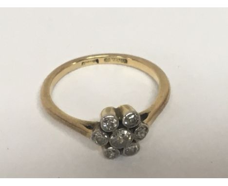 An 18carat gold ring set with a pattern of old cut diamonds one central stone flanked by six ring size M. Weight 3g