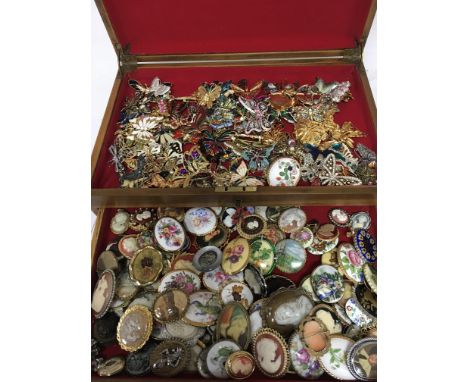 A large collection of vintage brooches including butterflys and cameos. Postage cat C