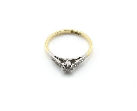 An 18ct gold and platinum ring set with a small diamond. Size L 1/2 and 2.10g