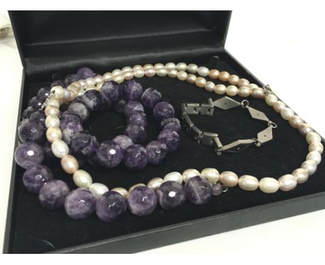 A pearl necklace, a beaded amethyst necklace, matching bracelet and a titanium bracelet. postage category B. NO RESERVE