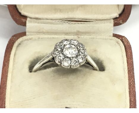 A white high carat gold ring set with old cut diamonds , size P. Postage category A