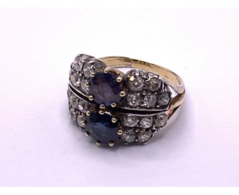 An Unmarked (tested) 18ct gold single sapphire and diamond cluster cocktail ring (Mix of Diamonds and Moissonite etc) (A).