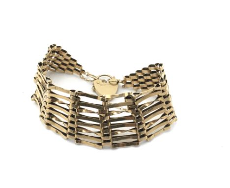 A 9ct gold gate bracelet with heart padlock. 15.32g Postage A