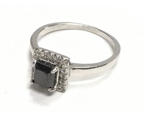 Certificated platinum ring set with square cut black diamond and a halo of RBC diamonds. Black diamond 0.60ct. Framing diamon