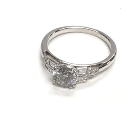 Certificated 18ct white gold diamond solitaire ring set with RBC and baguette cut diamond shoulders, boxed. Solitaire 0.90ct.