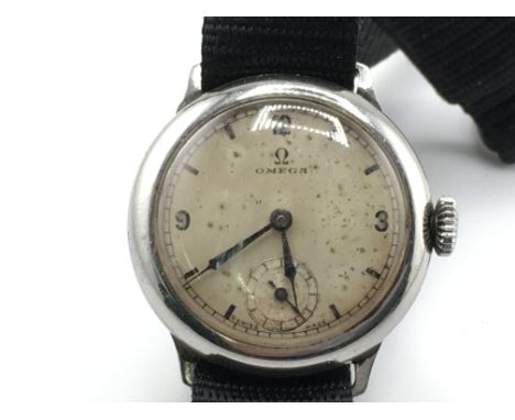 A vintage Omega watch on canvas strap. Approximately 1930's with 31mm case. Wind and runs. Postage B