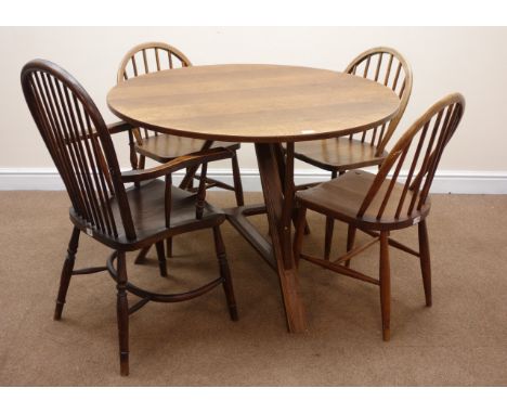 20th century circular oak dining table, three supports joined by  stretchers (D107cm, H75cm) and four (3+1) stick back chairs