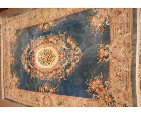 Large Chinese blue ground washed woollen rug carpet, central medallion, floral repeating border, 490cm x 308cm Condition Repo