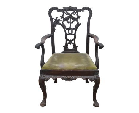 An Edwardian Chippendale style carved mahogany armchair, 1900s, the ribbon tied back above acanthus carved open arms, the dro