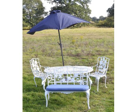 A white-painted metal garden table, 64cm high x 141cm wide x 82cm deep, together with a pair of armchairs, with foliate backs