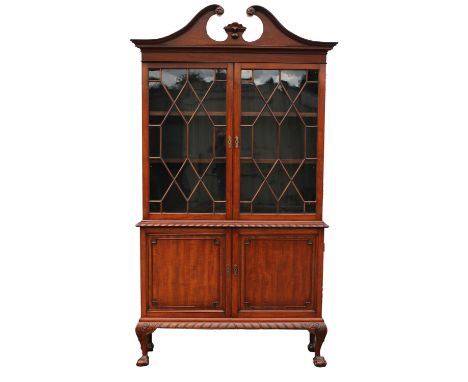 A George III Chippendale style mahogany display cabinet cupboard, in two parts, with swan neck pediment, adjustable shelves a