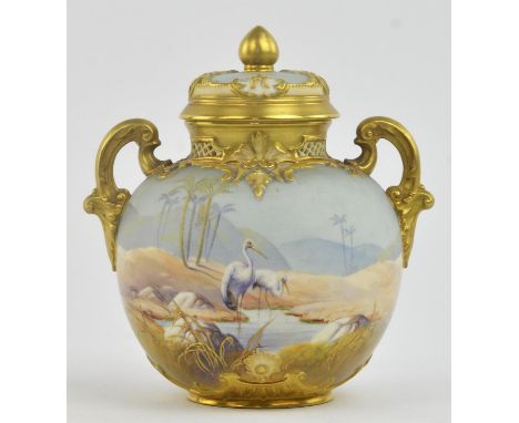 A Royal Worcester twin handles pot pourri vase and cover, decorated by A Shuck, with a continuous scene of a dessert landscap