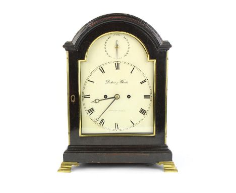 A 19th century ebonised, arch top bracket clock with brass single handle over a white painted dial detailed 'Debois & Wheeler