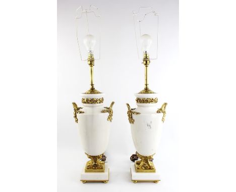 A pair of Empire style white marble and ormolu mounted table lamps of urn form, each finely cast with trailing ivy over a ste