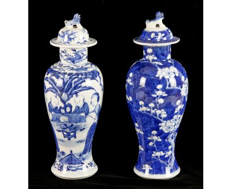 Two blue and white Chinese vases; one decorated with a prunus design and with Kangxi-four-character mark on the base; the oth