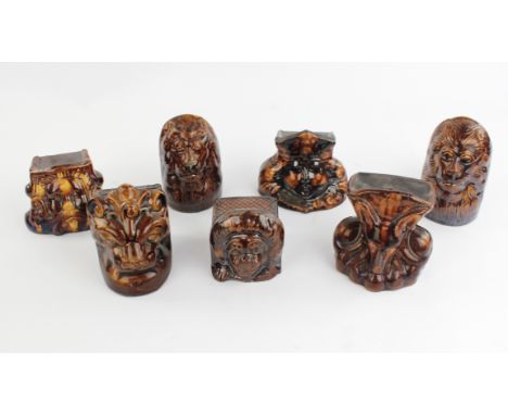 Seven Victorian stoneware sash window stops, each moulded with an amalier subject, the tallest 12cm and five matching Victori