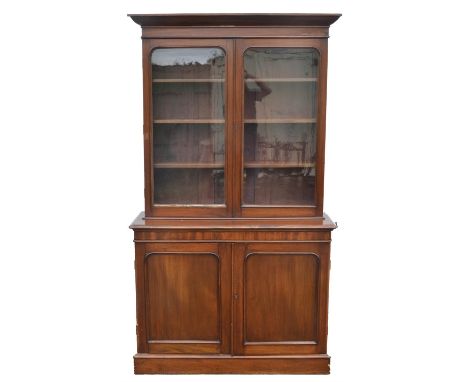 A Victorian mahogany bookcase cabinet, the top with three adjustable shelves, the base with arched doors enclosing a shelf, H
