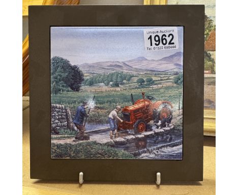 A ceramic teapot stand featuring a tractor.