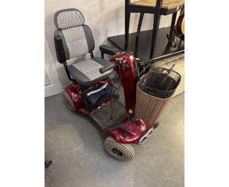 A Shopper Cadiz full suspension 8+ Mpg mobility scooter. All working with extra shopping baskets, charger etcSeat back & arms
