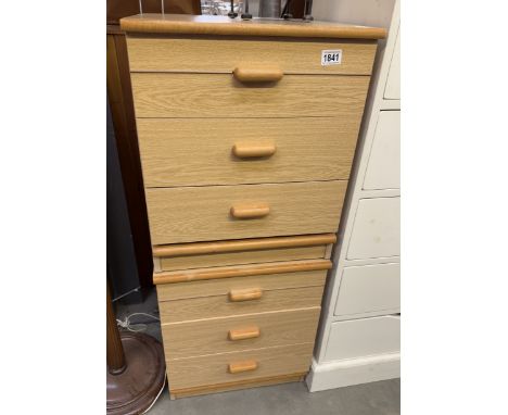 A pair of light wood bedside chest of drawers
