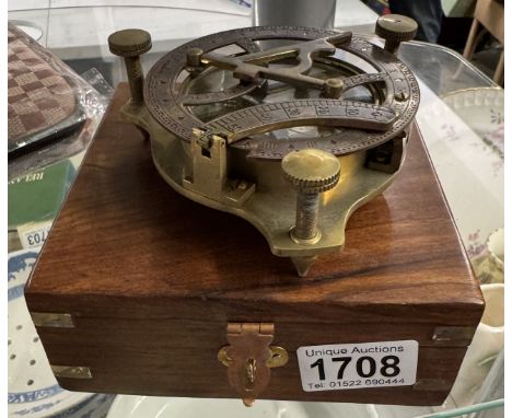 A brass multi sextant / sundial in brass bound teak box