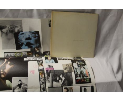A top loading Beatles White album numbered 0334085, which comes with poster but no band inserts. Light sleeve wear as shown i