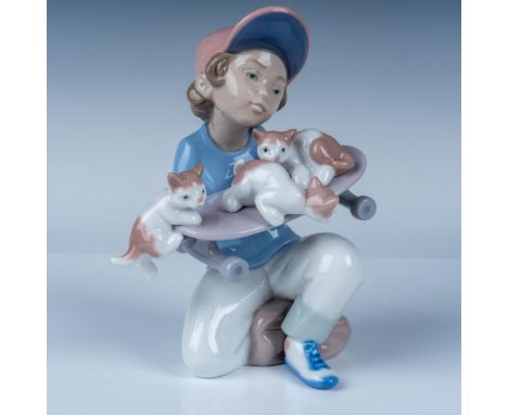 This delightful Lladro porcelain figurine, titled Little Riders (No. 1007623), depicts a young boy kneeling as he gently bala